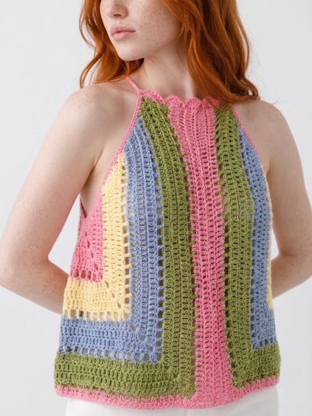 Jasmine Crochet Halter Neck Top Size 10 - 12 UK Woman wearing a colourful, crocheted halter top with geometric patterns.